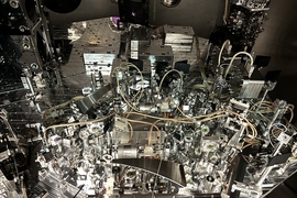 The inside of the LIGO chamber is shiny and metallic, with lenses and cords.